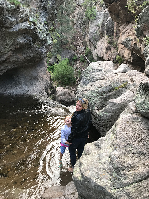 deann standing in a rock pool with her daughter